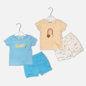 Two baby girls summer sets from Mini & Me: a sky blue t-shirt with matching blue shorts and a beige rainbow t-shirt with white rainbow-printed shorts.