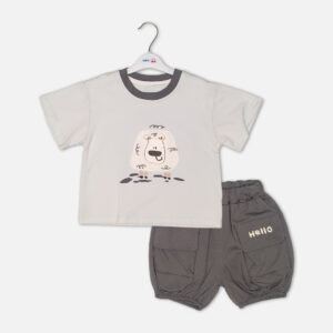 Toddler boy 2-piece summer clothing set featuring a cream t-shirt with a cartoon sheep graphic and a charcoal grey crewneck collar paired with matching grey harem-style cargo shorts with "Hello" pockets from Mini & Me.
