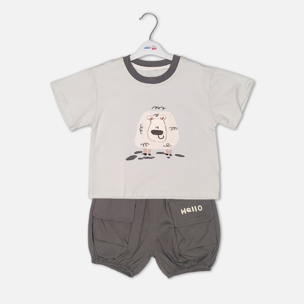 1-2 Toddler boy 2-piece summer clothing set featuring a cream t-shirt with a cartoon sheep graphic and a charcoal grey crewneck collar paired with matching grey harem-style cargo shorts with "Hello" pockets from Mini & Me.