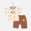 Toddler boy 2-piece summer clothing set featuring a cream t-shirt with an all-over Crayon Shin-chan character graphic print paired with matching brown shorts from Mini & Me.