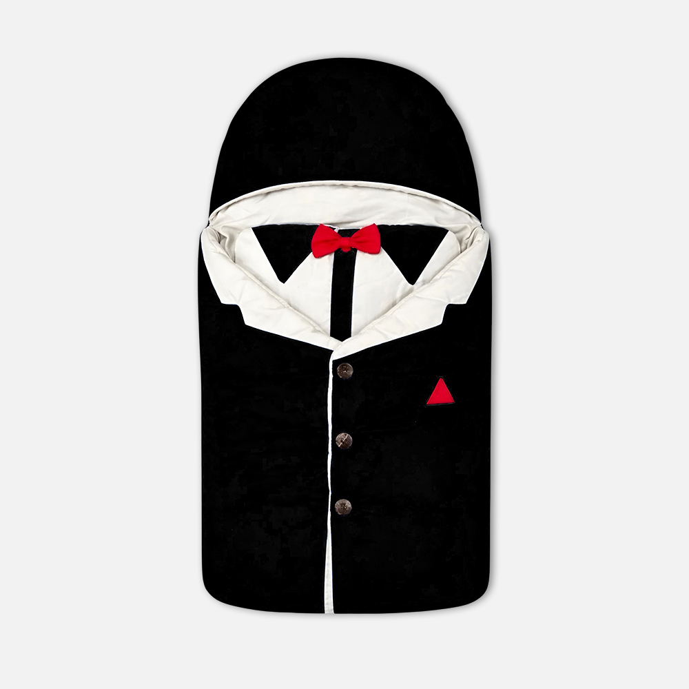 CarryNest5 Dapper black and white tuxedo-style baby carry nest featuring a bright red bow tie, decorative buttons, and an integrated hood from Mini & Me,
