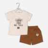 Toddler boy 2-piece summer clothing set featuring a cream t-shirt with a green "Cragging" graphic print, paired with matching brown elasticated shorts detailed with a cartoon bear face pocket from Mini & Me.