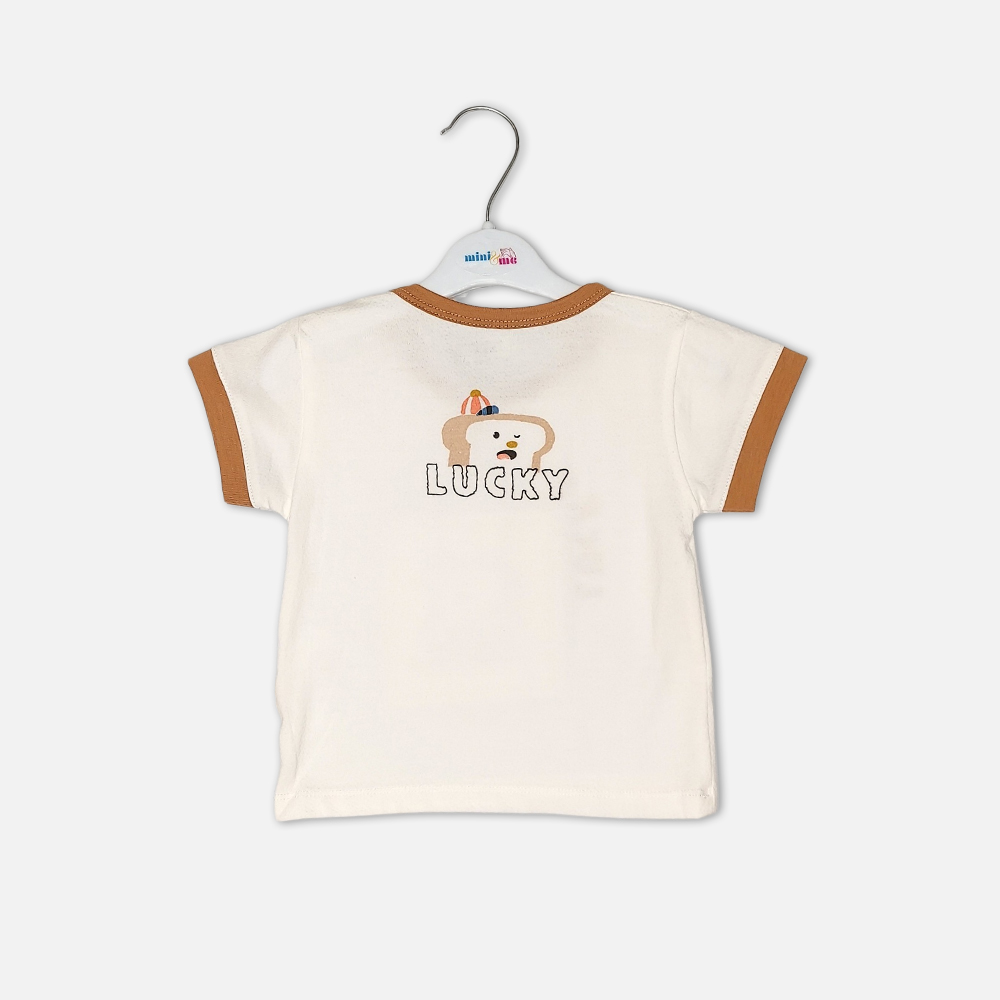boysSuit14172-1-5 Toddler boy 2-piece summer clothing set featuring an off-white t-shirt with a "Lucky" cartoon toast graphic and tan trim details, paired with matching tan elasticated shorts from Mini & Me.