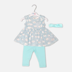 Baby girl 3-piece summer clothing set showcasing a sleeveless sky blue frock with a white smiling cartoon cloud print and shoulder ruffles, displayed alongside matching mint green leggings and a knotted bow headband from Mini & Me.