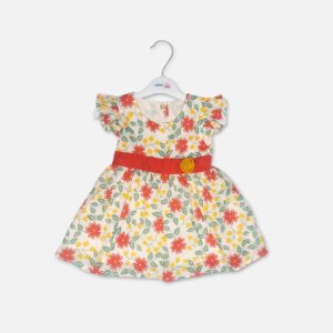 Baby girl off-white cotton frock with red floral prints, ruffle sleeves, and a red waistband with a yellow fabric flower hanging on a white hanger.