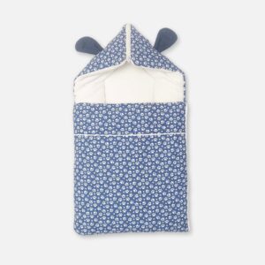 A premium newborn convertible carry nest sleeping bag featuring a blue exterior print with white stars and paw prints, a soft off-white cushioned interior, and a convertible zippered hood accented with cute dark blue 3D ears.