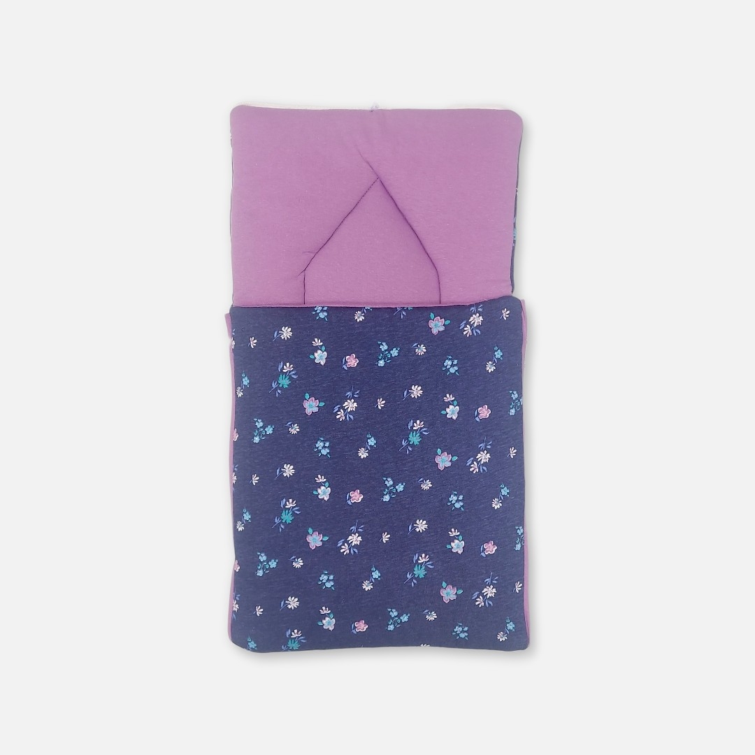 20260711_171527 (6) A premium newborn convertible carry nest sleeping bag featuring a navy blue exterior print with tiny pink and purple flowers, a soft lilac purple cushioned interior, and a convertible zippered hood accented with cute matching floral 3D ears.