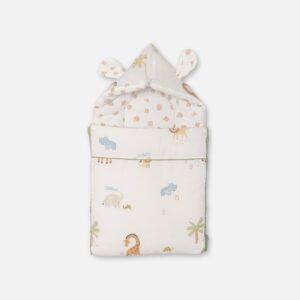 A convertible cream-colored baby carry nest featuring a pastel safari animal print with elephants, giraffes, and lions, showing both the open rectangular bedding layout and the zipped hooded setup with fabric ears.