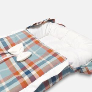 Newborn baby carry nest and matching head-support pillow featuring a blue and orange plaid pattern with a white fabric bow accent on the front.