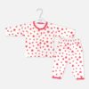 Unisex white cotton baby sleepwear set featuring a long-sleeve button-up top and matching pull-on pants decorated with an all-over pink heart print and pink trim.