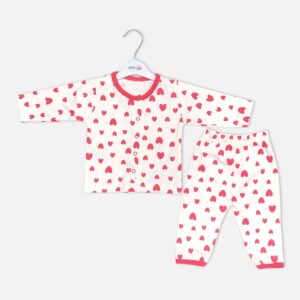Unisex white cotton baby sleepwear set featuring a long-sleeve button-up top and matching pull-on pants decorated with an all-over pink heart print and pink trim.