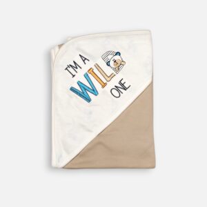 A folded linen-beige and white 100% cotton hooded baby blanket featuring an embroidered cartoon bear and the text "I'm a Wild One" on the solid white corner hood section, set against a light background.