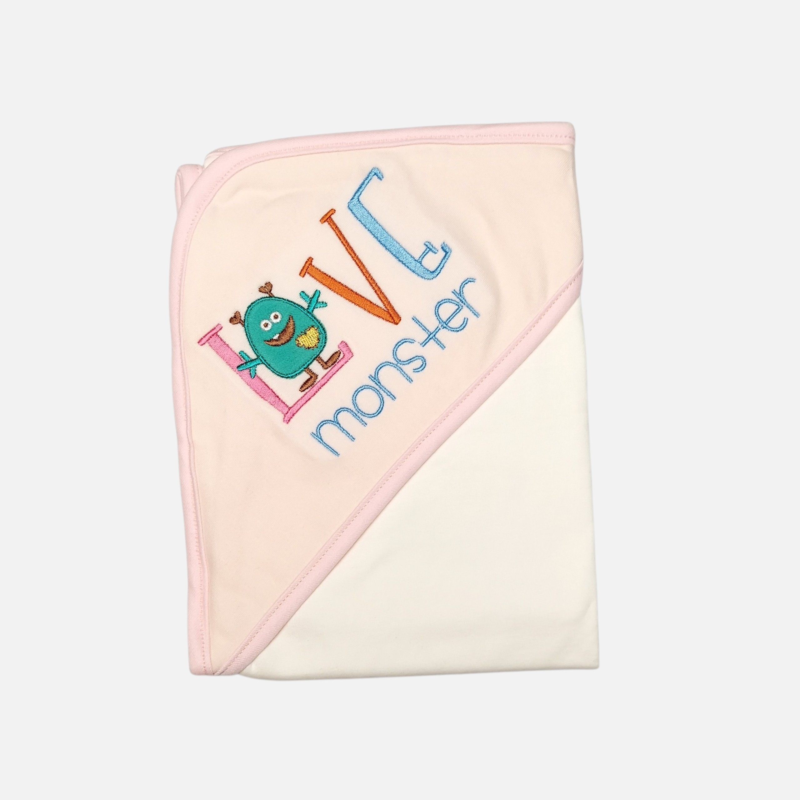 20260720_180530 (8) (17) A folded light pink and cream hooded baby blanket featuring a colorful embroidered text that reads Love Monster with a cute green monster character graphic.