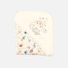 A folded linen and white 100% cotton hooded baby blanket featuring an embroidered dinosaur design with pink stars on the corner hood section and a repeating multi-colored cartoon safari animal and star print on the main fabric body.