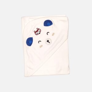 A folded off-white 100% cotton hooded baby blanket featuring a corner hood designed as a sleeping bear face with embroidered eyes, nose, whiskers, dimensional blue fabric ears, and a small embroidered fox motif.