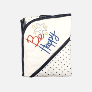A folded cotton hooded baby blanket featuring a clean white corner hood with embroidered stars and Be Happy text details, alongside a white fabric body decorated with a navy blue polka dot pattern.