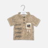 A toddler boys' short-sleeve polo shirt in a beige acid-wash crinkle texture, featuring a structured polo collar with three black buttons, a repeating typography print on the side, and a graphic patch pocket, shown hanging on a white hanger.