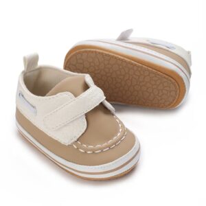 Beige and white faux leather baby boat shoes with a single velcro strap and a textured non-slip tan sole.