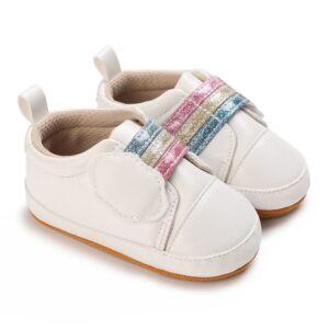 Pair of white faux leather baby pre-walker sneakers featuring a cloud-shaped hook-and-loop strap closure, three sparkling glitter elastic bands in pink, gold, and blue, a soft fabric lining, and a flexible tan-colored soft sole.