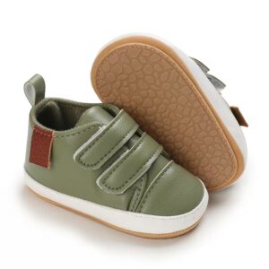 Olive green leather baby sneakers with a white sole border, double velcro straps, a small brown accent patch, and a textured tan non-slip sole.
