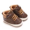 Pair of chocolate brown faux leather high-top baby sneakers with camel-tan padded ankle collars, tan elastic laces, a single hook-and-loop strap, and a white sole border.