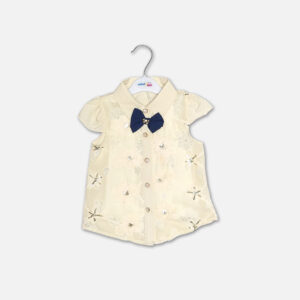 A premium two-piece baby girls clothing set featuring an off-white cap-sleeve button-down shirt with embroidered flowers, sequins, and a navy bow tie, alongside a pleated navy blue skirt with gold stripes and a metallic gold belt, displayed on a hanger.