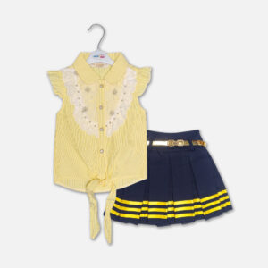 A premium two-piece summer outfit for baby girls consisting of a yellow and white pinstriped button-down blouse with a white lace embroidered bib and tie-front knot, paired with a pleated navy blue skirt featuring horizontal yellow stripes and a metallic gold belt, shown on a white hanger.