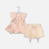 A premium two-piece formal clothing set for baby girls featuring a sleeveless peach-colored satin peplum top with a structured collar, rhinestone embellishments, and a fabric flower brooch, paired with beige shorts featuring rhinestone accents and a matching peach ribbon waist tie, displayed on a white hanger.
